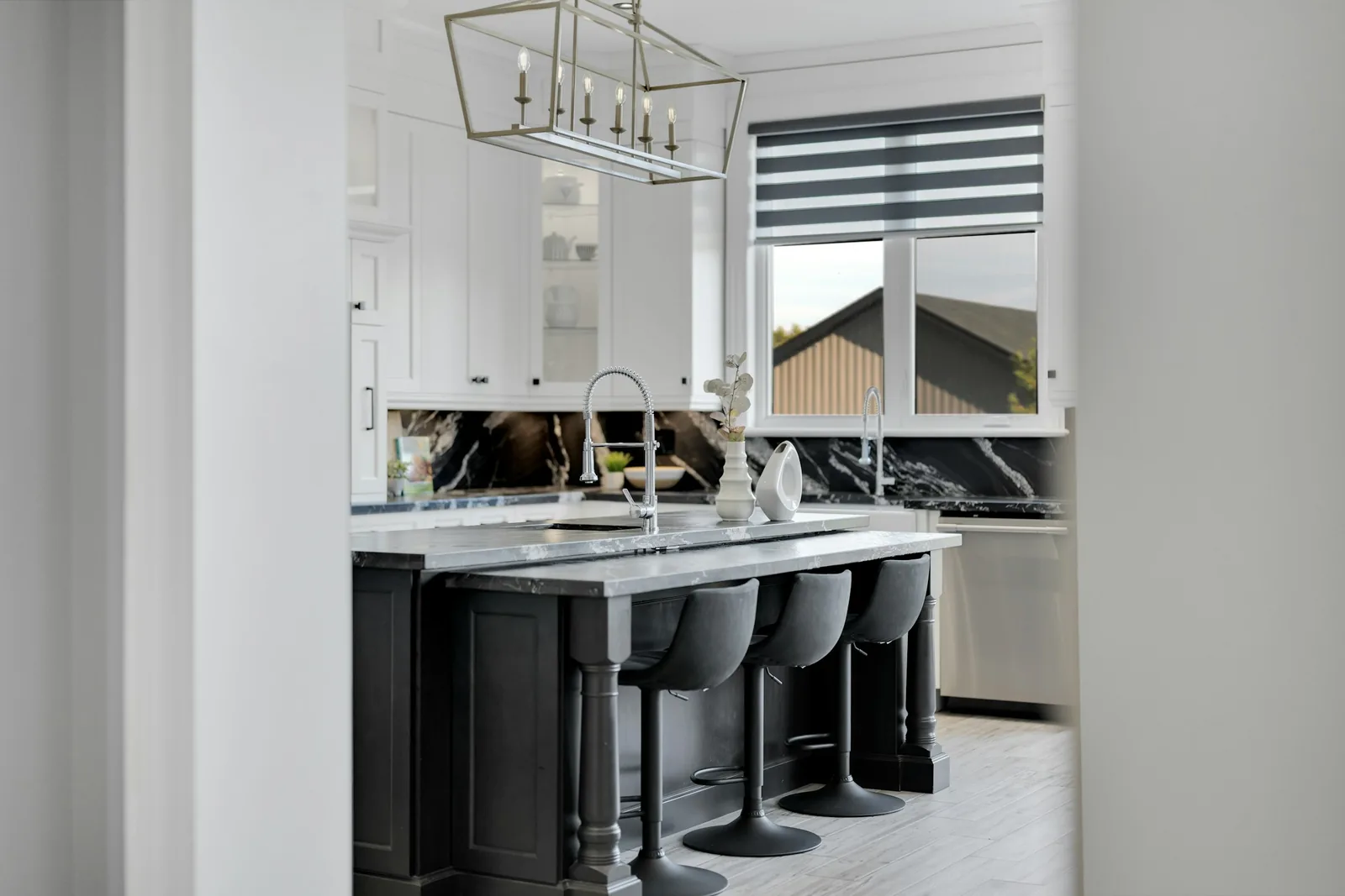 Upscale kitchen island with marble worktop, seating and sophisticated finishes